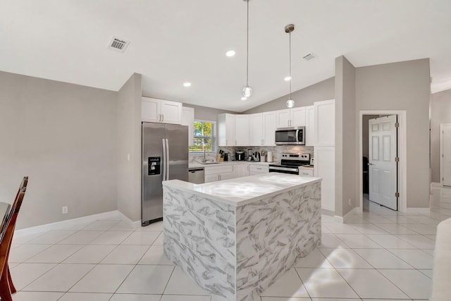 kitchen featuring light tile patterned floors, visible vents, lofted ceiling, appliances with stainless steel finishes, and tasteful backsplash