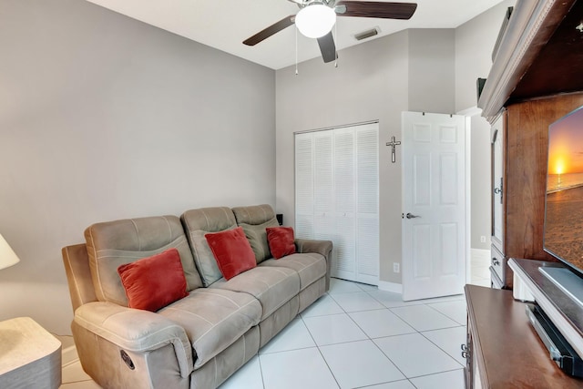 living room with light tile patterned flooring, baseboards, visible vents, and ceiling fan