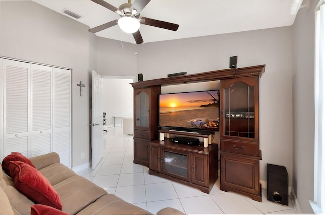 living room featuring light tile patterned flooring, visible vents, baseboards, and ceiling fan