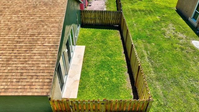 view of yard with a fenced backyard