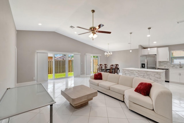 living area with light tile patterned floors, visible vents, recessed lighting, vaulted ceiling, and ceiling fan with notable chandelier