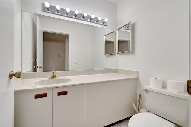 half bathroom featuring vanity and toilet