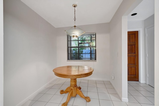 dining area featuring baseboards and light tile patterned flooring