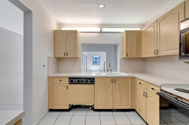 kitchen featuring dishwashing machine, light brown cabinets, light countertops, and a sink