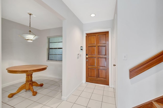 foyer entrance featuring light tile patterned floors and baseboards