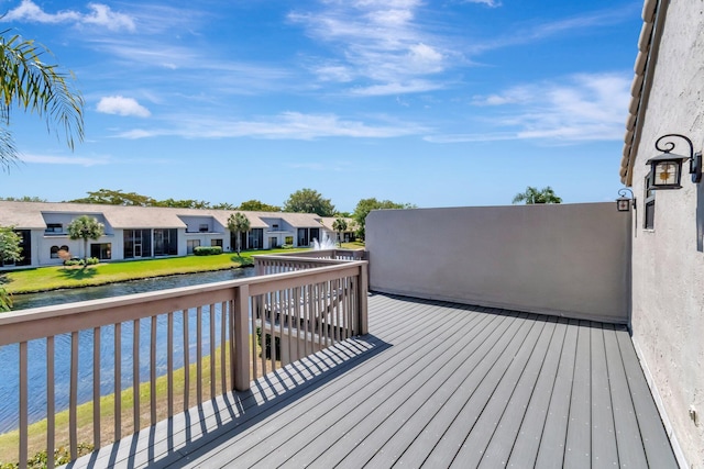 wooden terrace featuring a water view