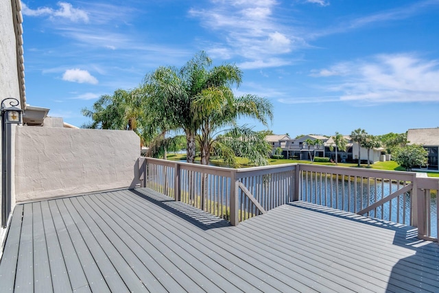 wooden deck featuring a residential view and a water view