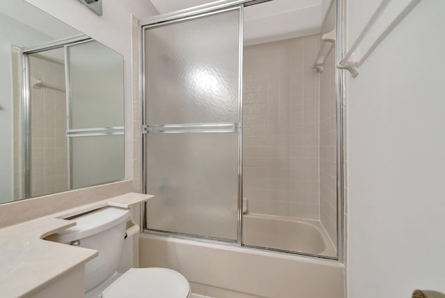 full bath with vanity, toilet, and combined bath / shower with glass door