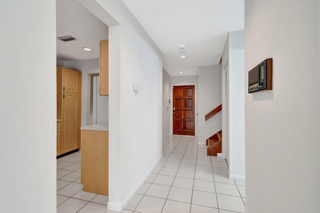 hall featuring visible vents, recessed lighting, light tile patterned flooring, baseboards, and stairs