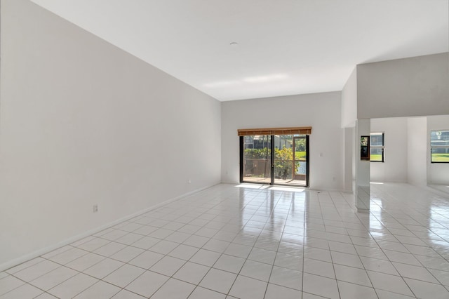 empty room with light tile patterned floors and baseboards