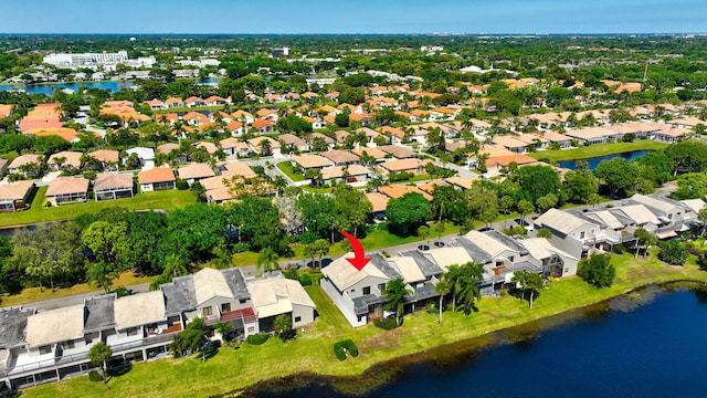 drone / aerial view featuring a residential view and a water view