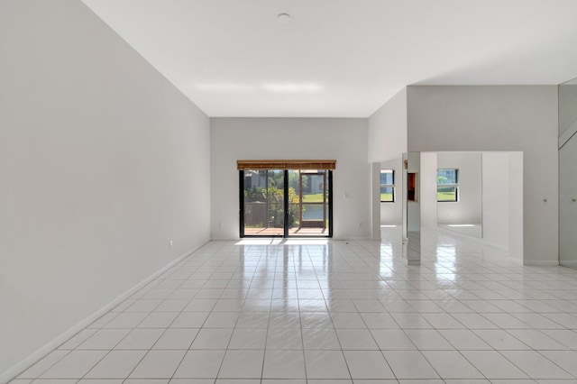 unfurnished room featuring light tile patterned flooring and baseboards