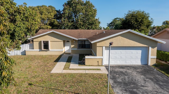 single story home featuring stucco siding, driveway, fence, a front yard, and a garage