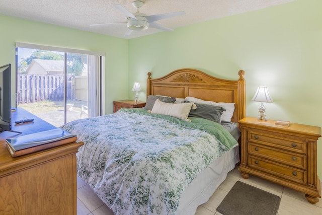 bedroom featuring light tile patterned floors, a textured ceiling, ceiling fan, and access to outside