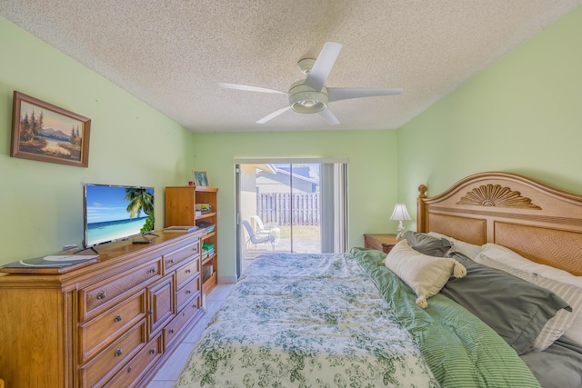 bedroom featuring access to exterior, a ceiling fan, and a textured ceiling