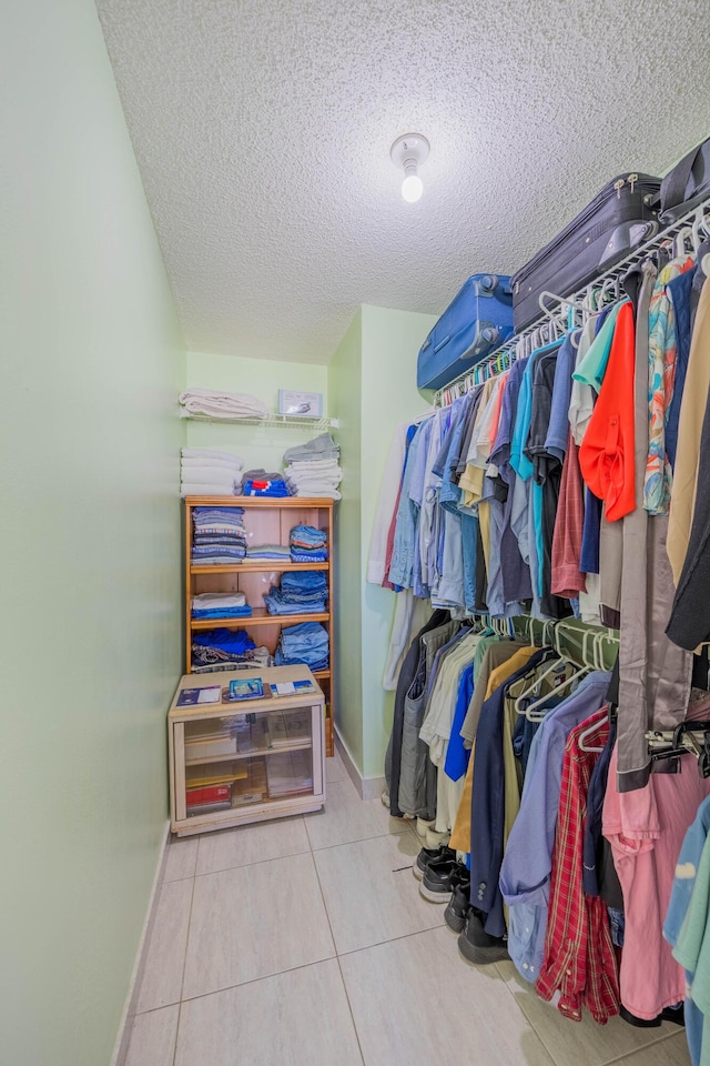 spacious closet with tile patterned floors