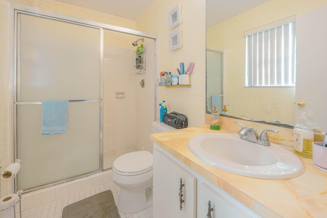 bathroom with tile patterned flooring, a stall shower, toilet, and vanity