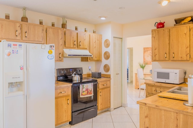 kitchen with white appliances, light tile patterned flooring, light countertops, and under cabinet range hood