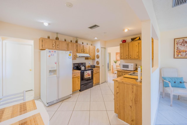 kitchen with under cabinet range hood, visible vents, white appliances, and light tile patterned floors