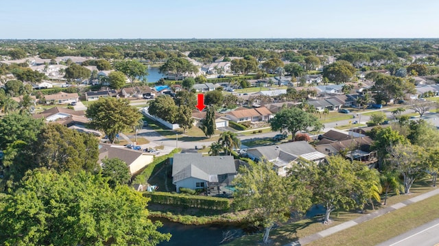 drone / aerial view featuring a residential view and a water view