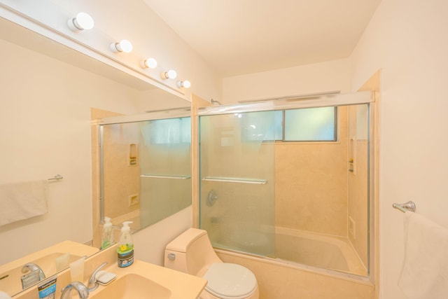 full bath featuring combined bath / shower with glass door, toilet, and vanity