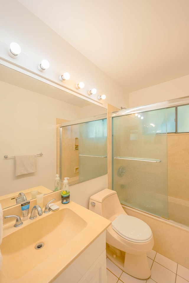 full bath with tile patterned flooring, vanity, toilet, and enclosed tub / shower combo