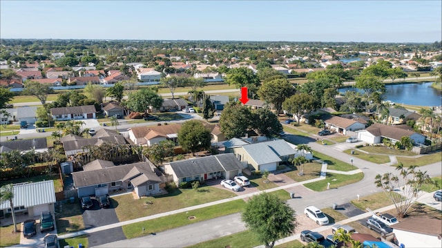 drone / aerial view featuring a residential view and a water view