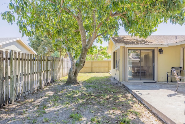 view of yard featuring a patio area and a fenced backyard