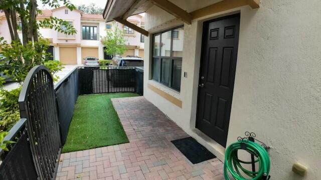 4780 Grand Cypress Cir N, Coconut Creek, FL 33073 - view of exterior entry with stucco siding
