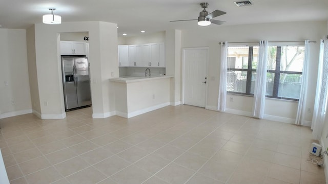4780 Grand Cypress Cir N, Coconut Creek, FL 33073 - kitchen featuring stainless steel refrigerator with ice dispenser, light countertops, ceiling fan, white cabinetry, and light tile patterned floors