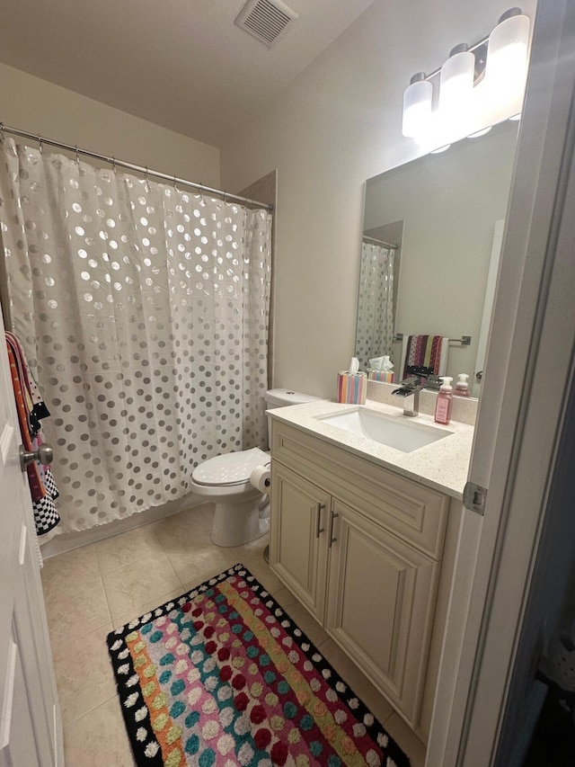 full bathroom featuring tile patterned floors, visible vents, toilet, and vanity