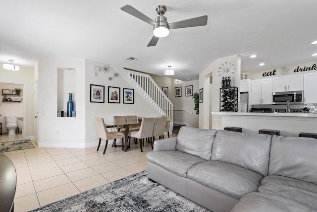 living room featuring stairway, recessed lighting, light tile patterned flooring, ceiling fan, and visible vents