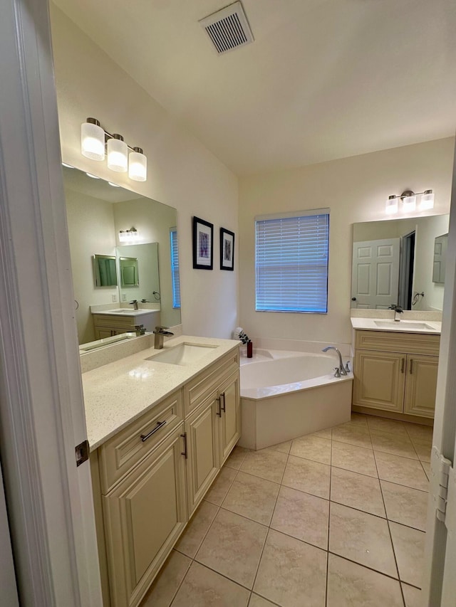 full bath featuring a sink, visible vents, a bath, and tile patterned floors