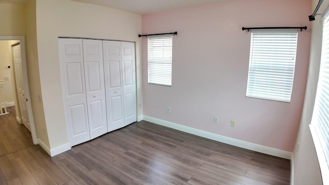 4780 Grand Cypress Cir N, Coconut Creek, FL 33073 - unfurnished bedroom featuring wood finished floors and a closet