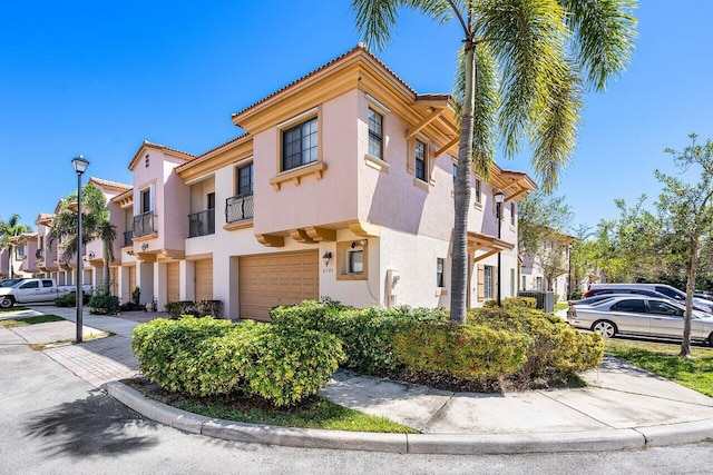view of home's exterior featuring a residential view, stucco siding, and an attached garage
