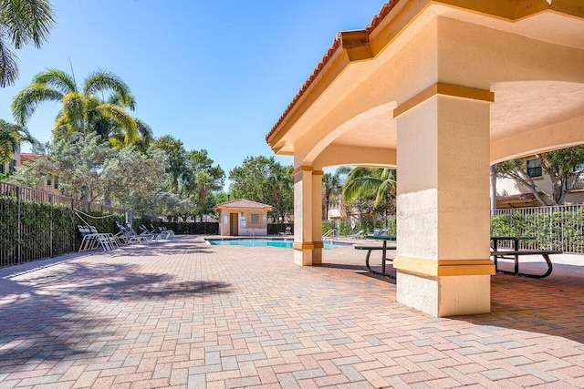 exterior space featuring fence, a swimming pool, and a patio area