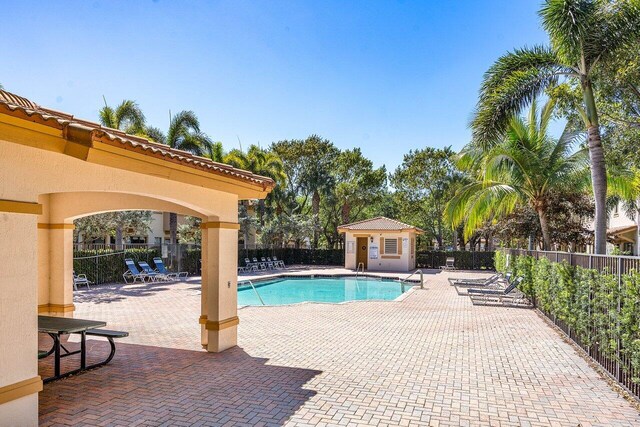 pool featuring fence and a patio