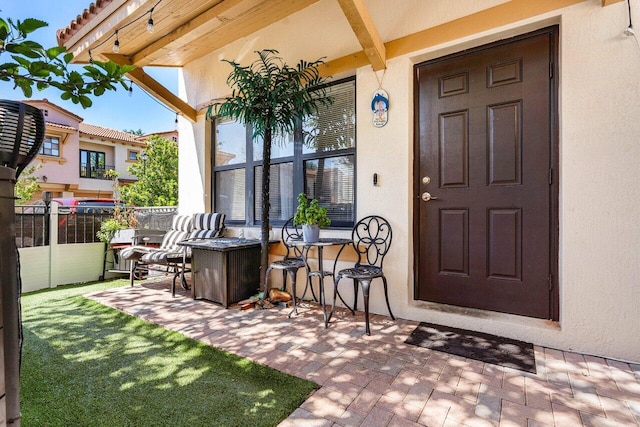 doorway to property featuring stucco siding
