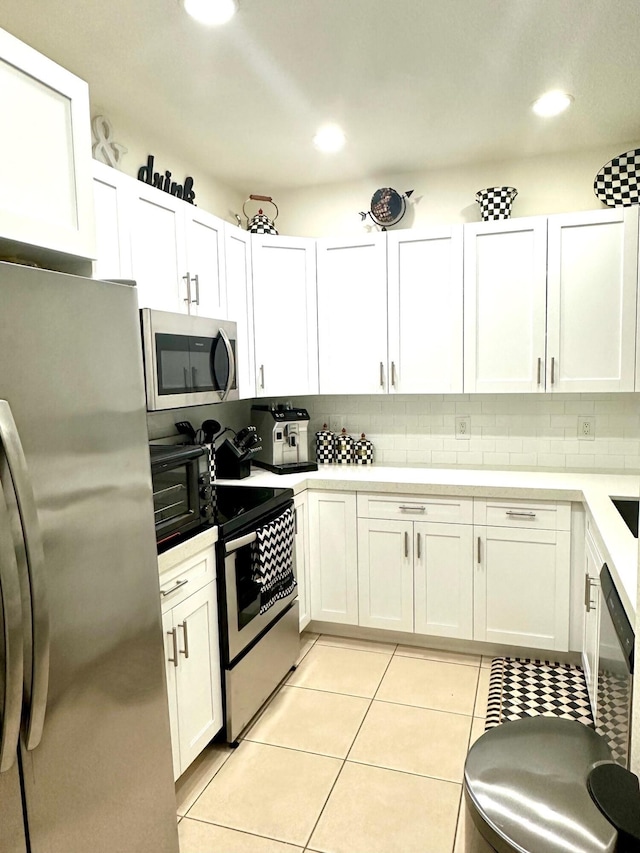 kitchen with light tile patterned flooring, recessed lighting, stainless steel appliances, decorative backsplash, and white cabinets