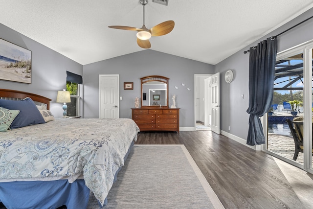 bedroom featuring visible vents, baseboards, dark wood finished floors, lofted ceiling, and access to outside