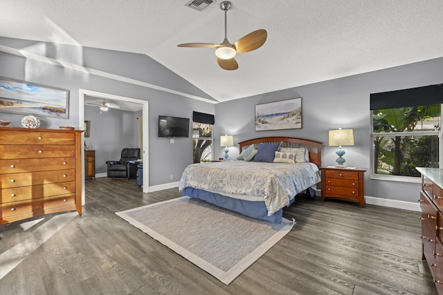 bedroom with baseboards, lofted ceiling, and dark wood finished floors