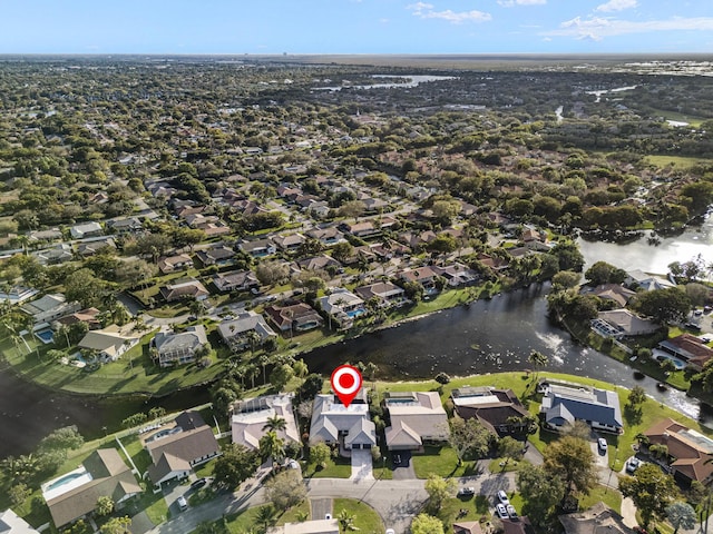 drone / aerial view featuring a residential view and a water view