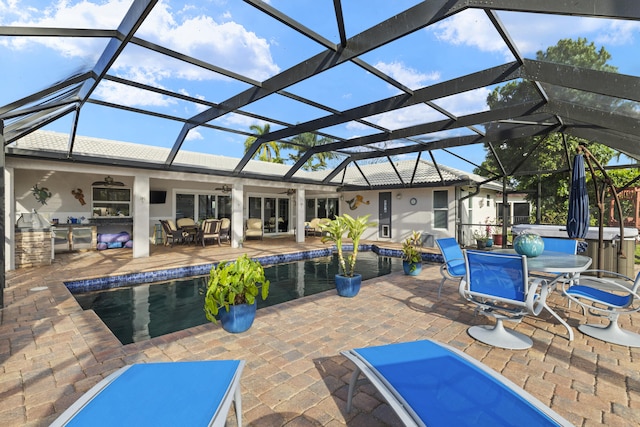 pool with ceiling fan, glass enclosure, outdoor dining area, a patio area, and a jacuzzi