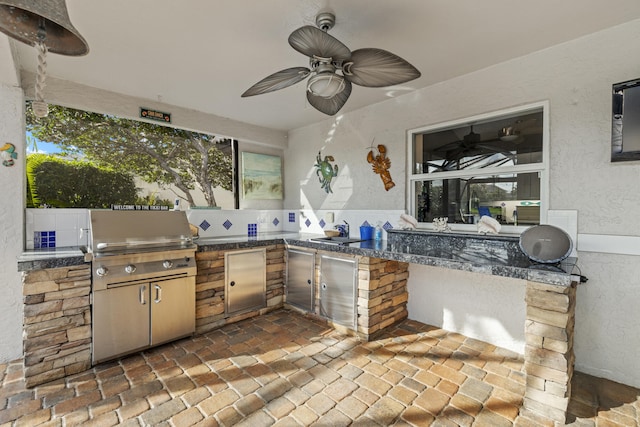 view of patio with a sink, area for grilling, and a ceiling fan