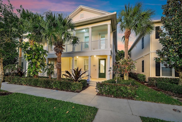 view of front of home featuring a porch and a balcony