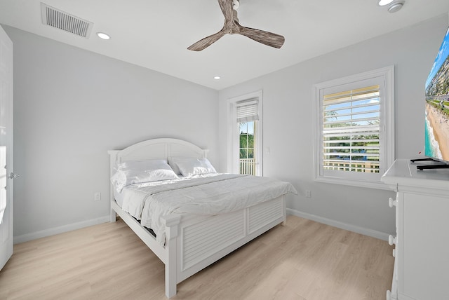 bedroom with light wood finished floors, visible vents, ceiling fan, and baseboards