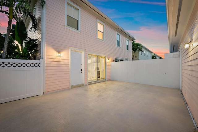 rear view of house with a patio area and fence