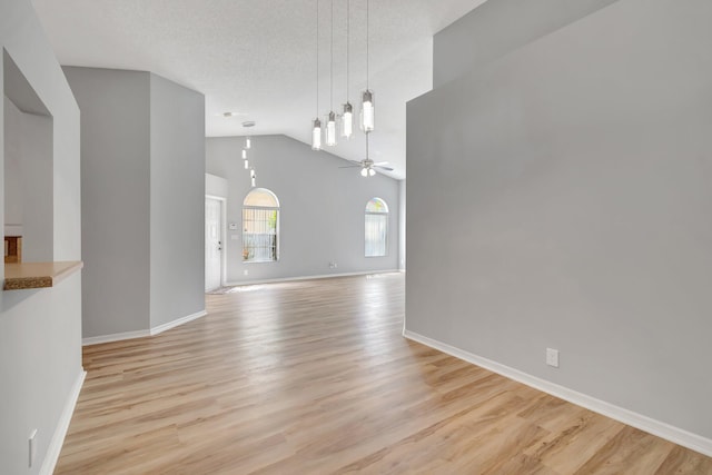 15443 Floral Club Rd, Delray Beach, FL 33484 - interior space with high vaulted ceiling, light wood-style flooring, a textured ceiling, baseboards, and ceiling fan