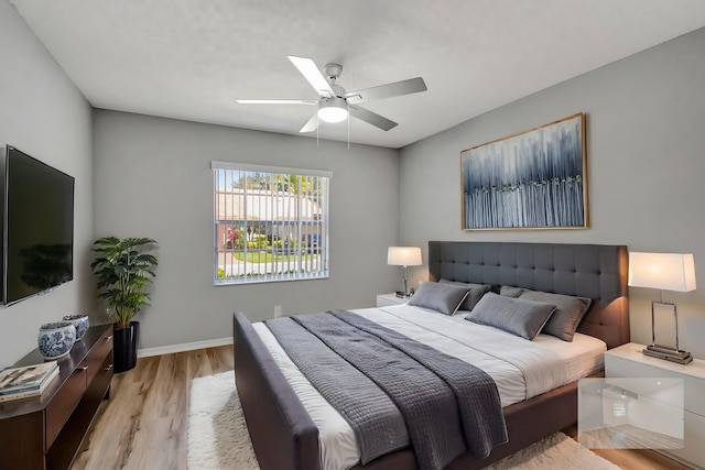 15443 Floral Club Rd, Delray Beach, FL 33484 - bedroom with light wood-style flooring, a ceiling fan, and baseboards