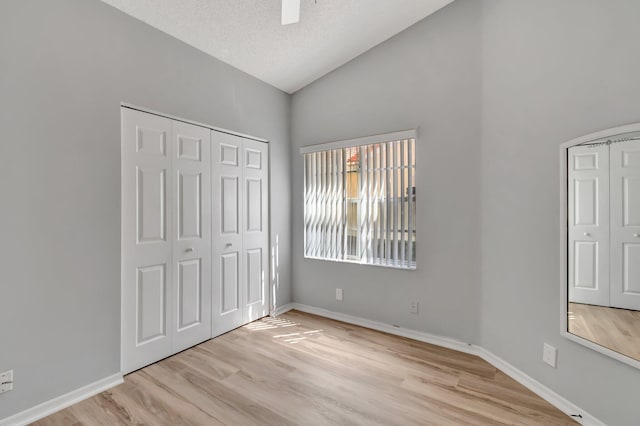 15443 Floral Club Rd, Delray Beach, FL 33484 - unfurnished bedroom featuring a textured ceiling, light wood-type flooring, baseboards, and vaulted ceiling